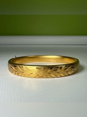 Napier gold-tone hinged bangle bracelet decorative floral etched design